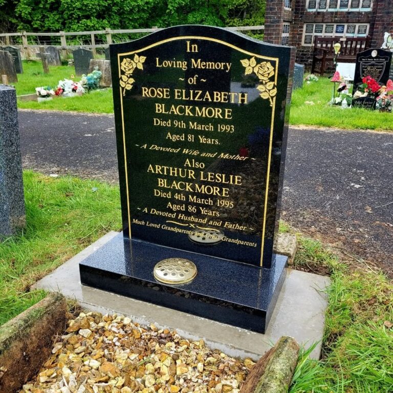 Black granite headstone with bold gold lettering