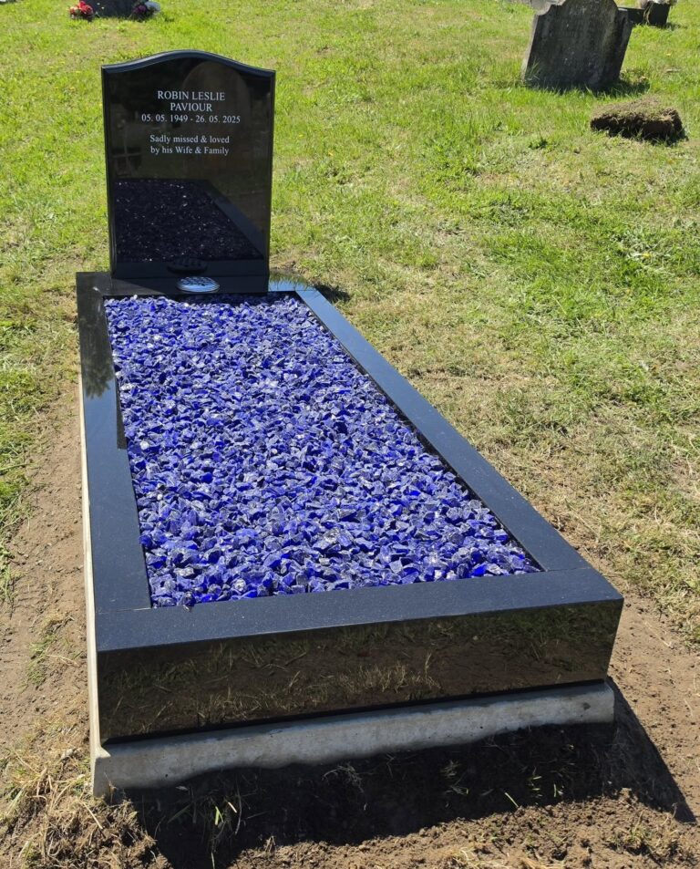 Black granite memorial with blue glass chippings