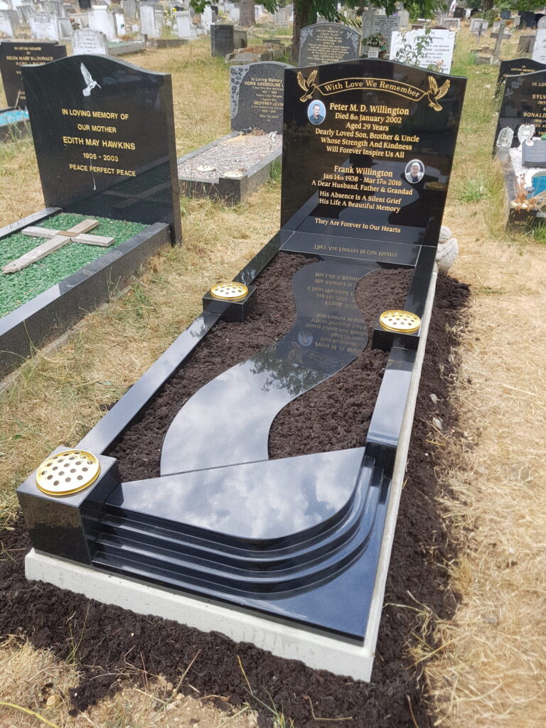 Polished black granite memorial with curved kerbs and gold lettering