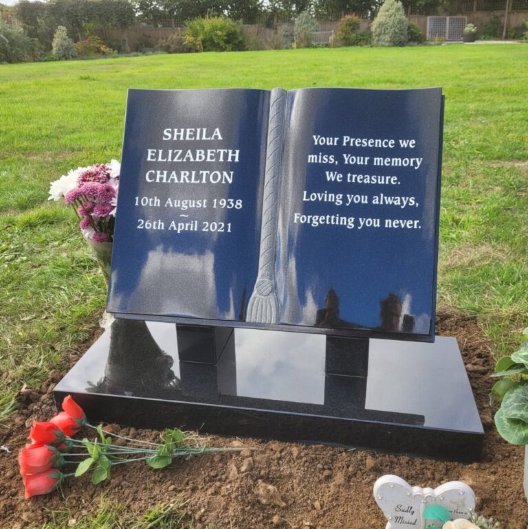 Black granite open book headstone