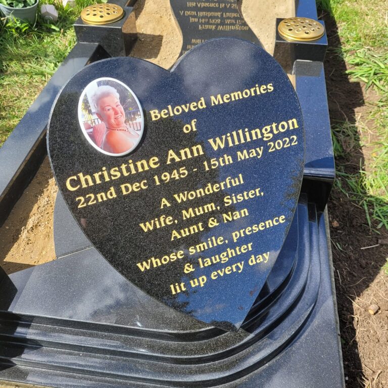 Curved black granite memorial with gold lettering