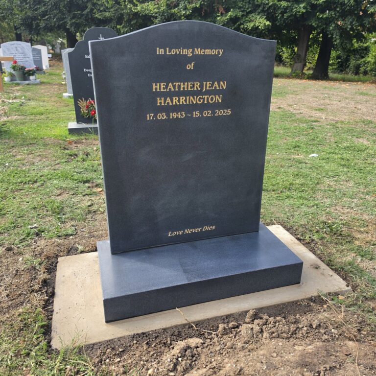 Dark grey granite headstone with gold lettering