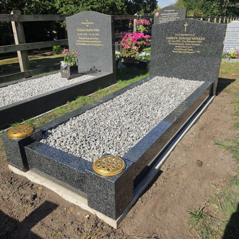 Grey granite headstone and kerb set with white chippings