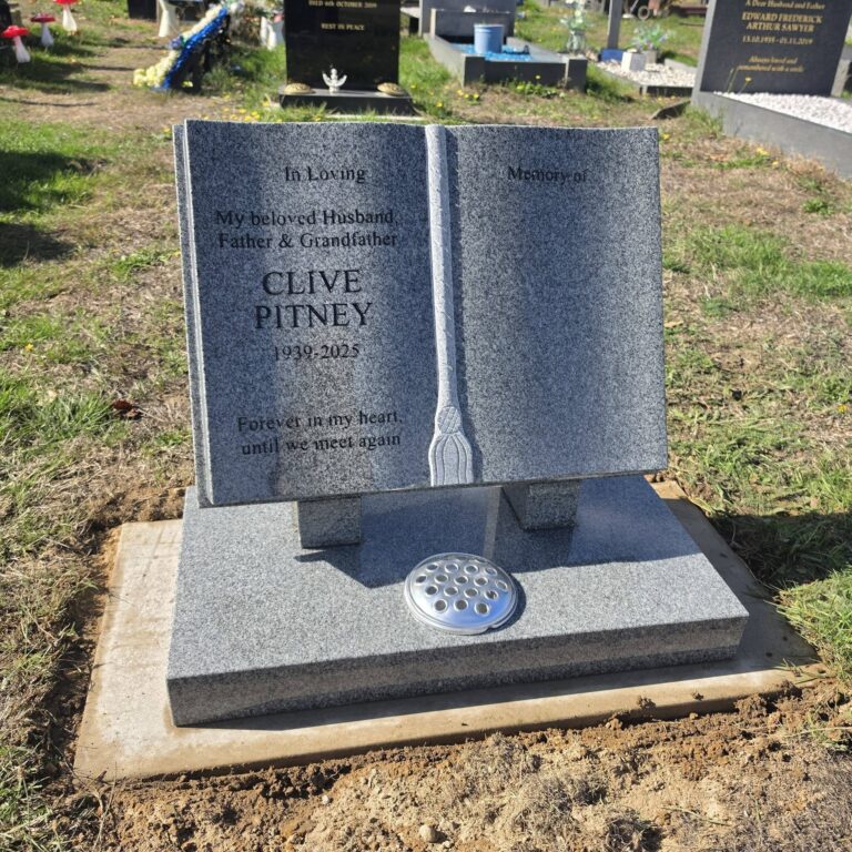 Grey granite open book headstone