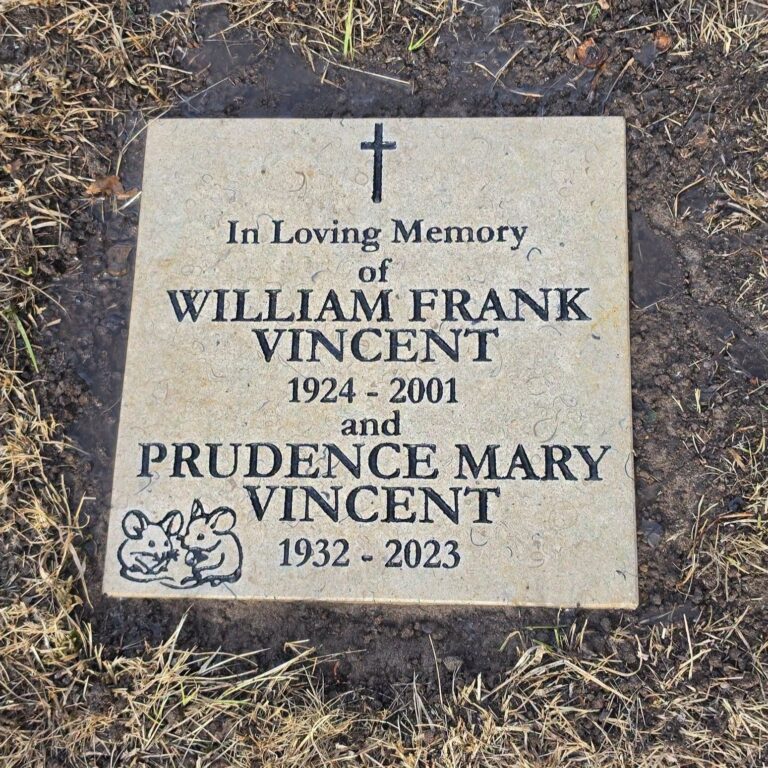 Light grey headstone with black lettering