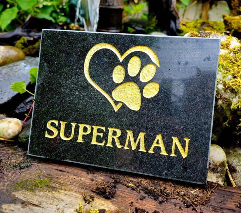 Black granite pet memorial plaque with a gold paw print