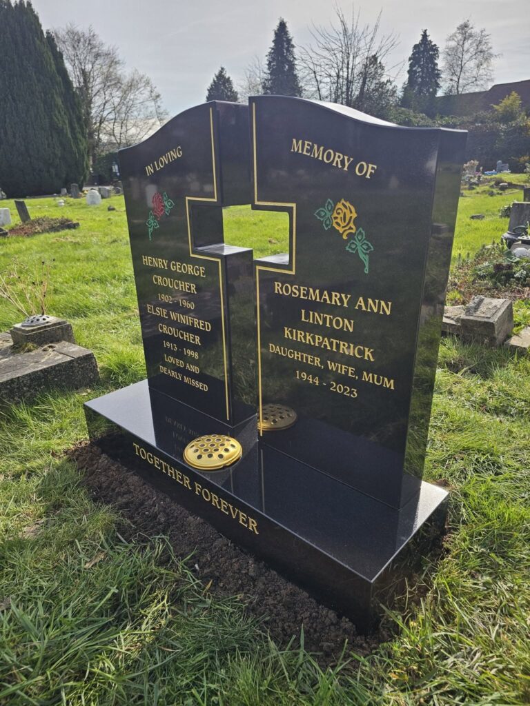 Shaped black granite headstone with gold lettering