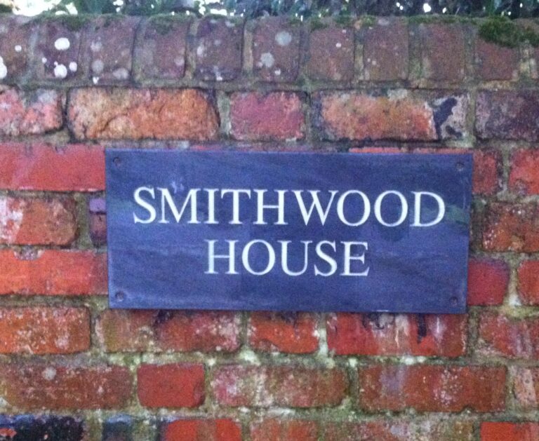 Smithwood House slate sign fixed to a red brick wall