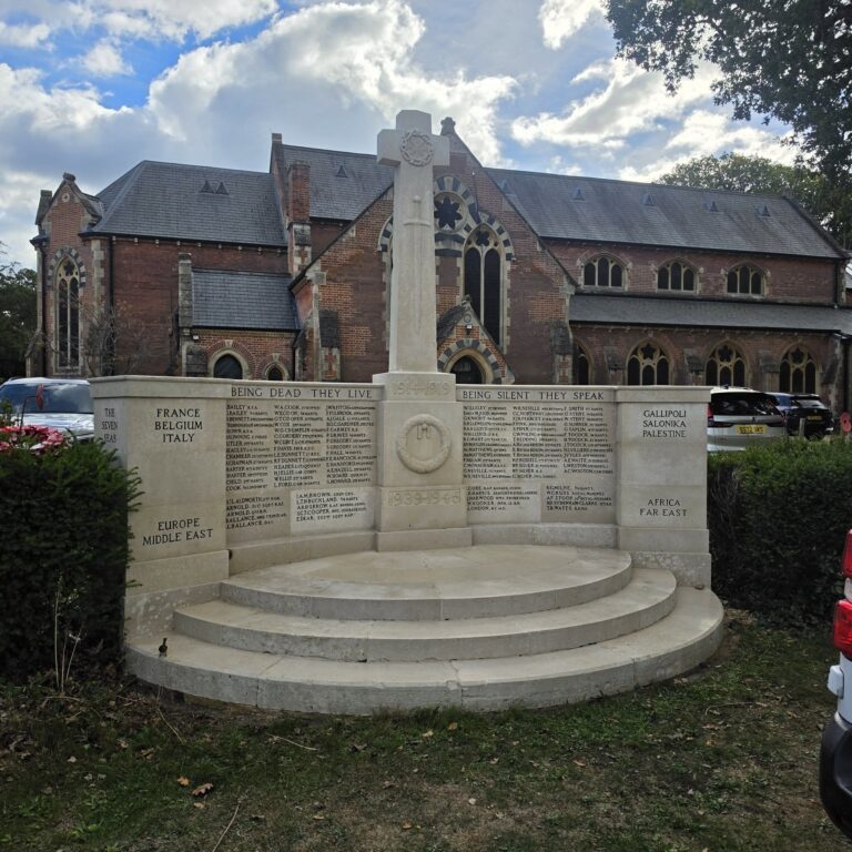 Restored stone war memorial on circular steps